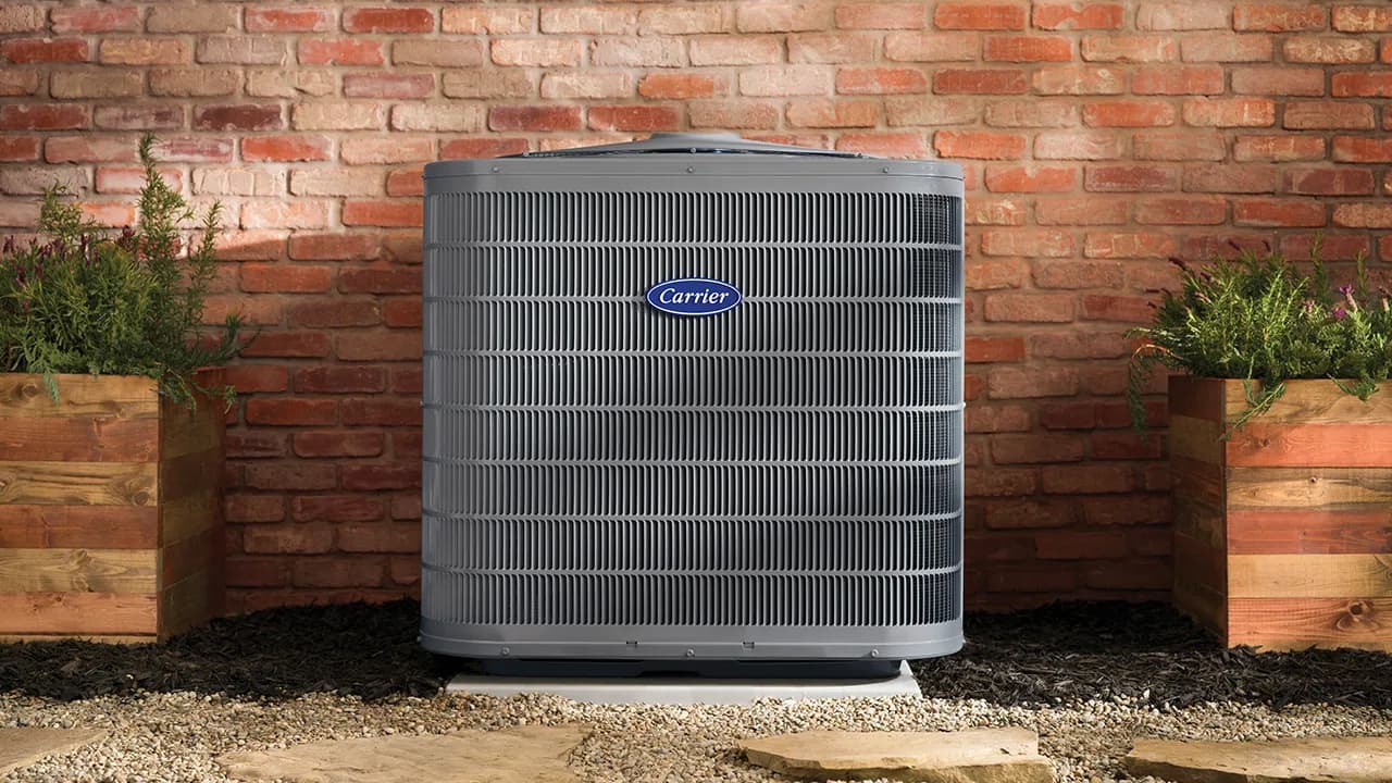 Carrier Performance series air conditioner outside a brick home