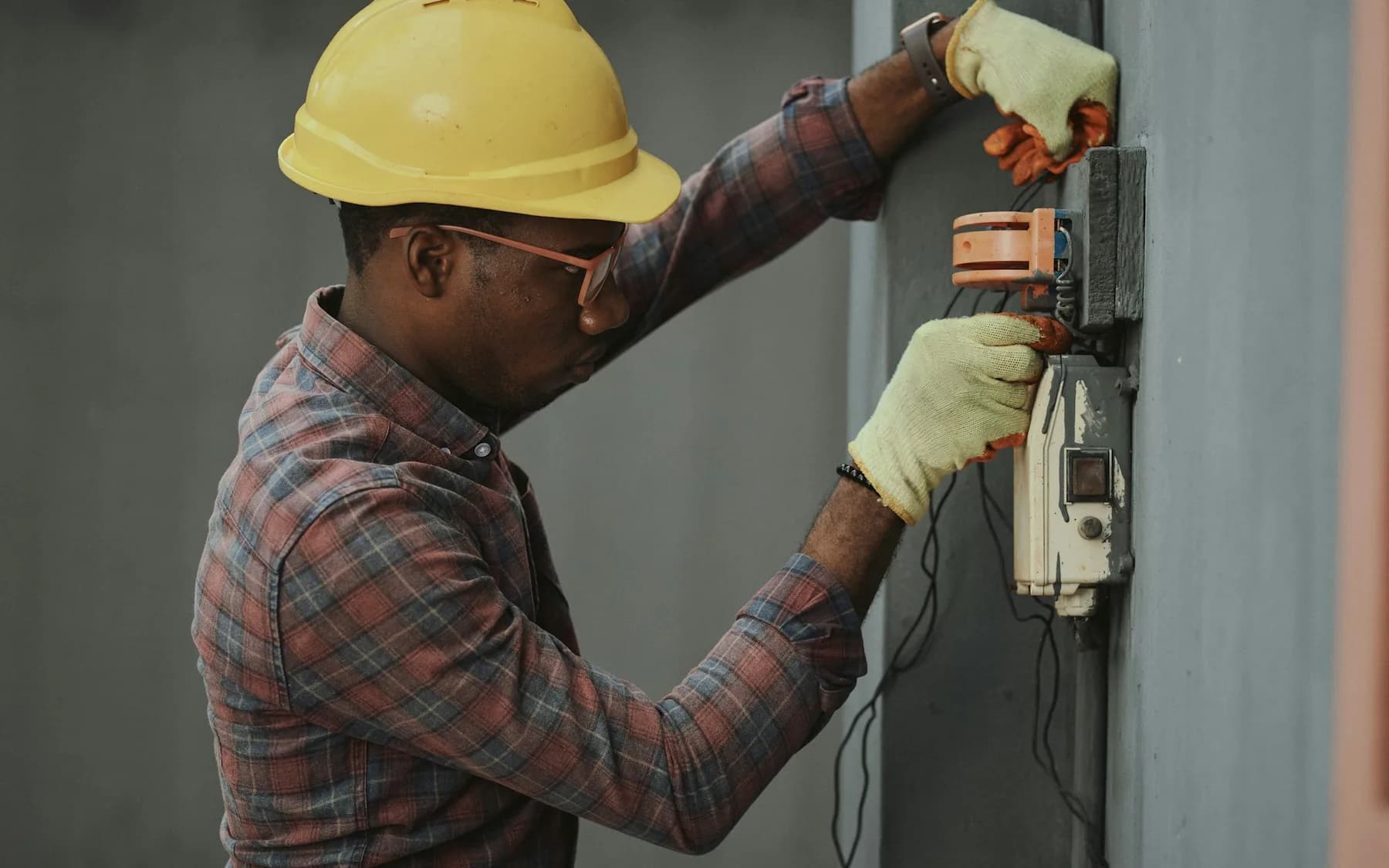 Tradesperson inspecting electrical connections during an equipment installation