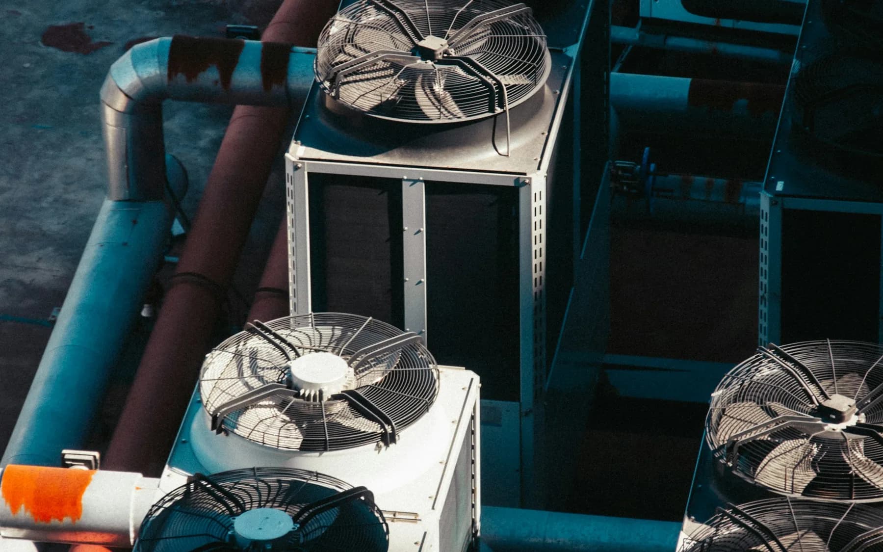 Several outdoor air-conditioning units arranged together on a rooftop