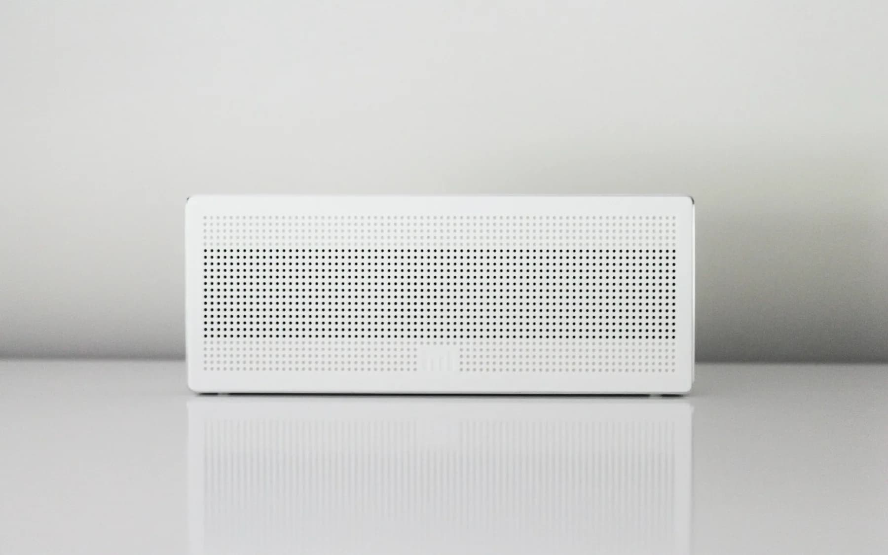 Clean rectangular air intake and filtration unit against a white wall