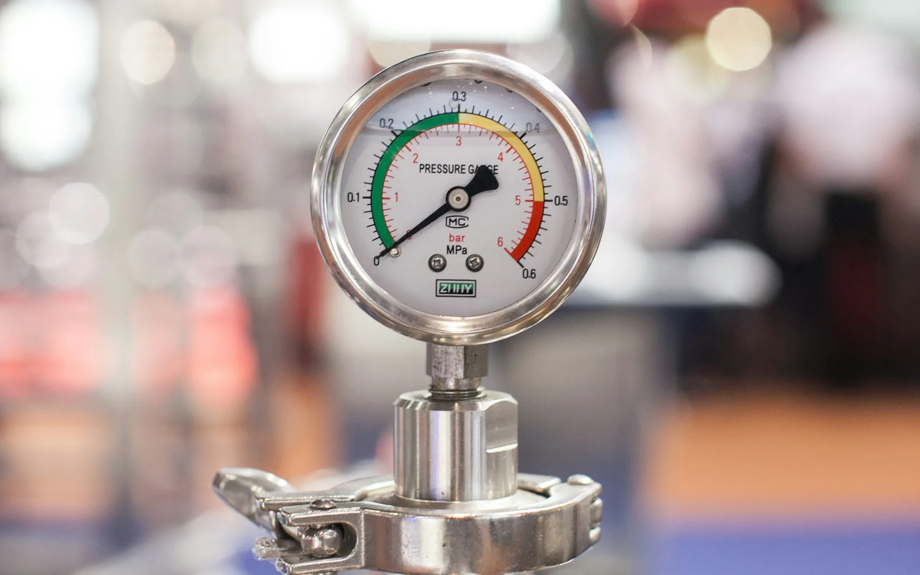 Close view of a calibrated pressure gauge attached to technical equipment