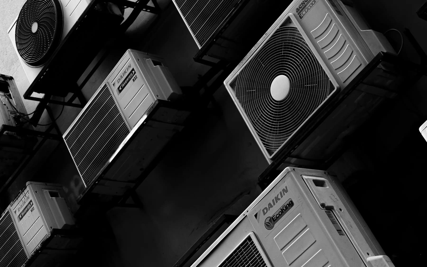 Multiple outdoor air-conditioning units mounted at different levels on a building